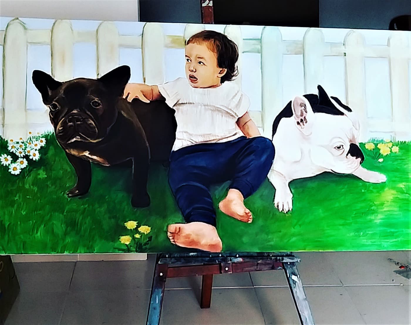 Çimenlikte iki köpeğiyle oturan çocuğu konu alan yağlıboya tablo